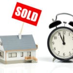 Sold sign on house and clock. Act now for your Last minute move
