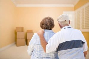 Elderly Couple Looking at Moving Boxes in New Hom