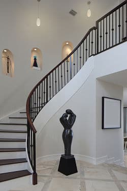 Entrance way to a Greenwich CT Home Where movers have Carefully placed statues and paintings on walls and up a spiral staircase