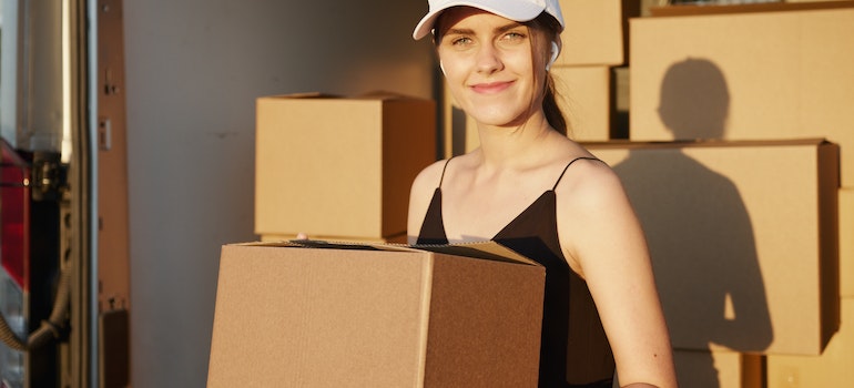 A woman carrying boxes