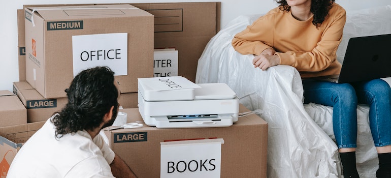 A couple packing for a move