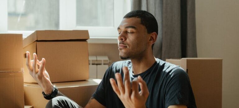 A man sitting near boxes