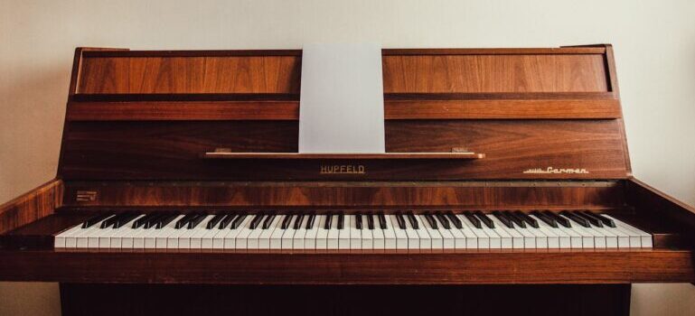 A brown piano moved by movers Westport CT