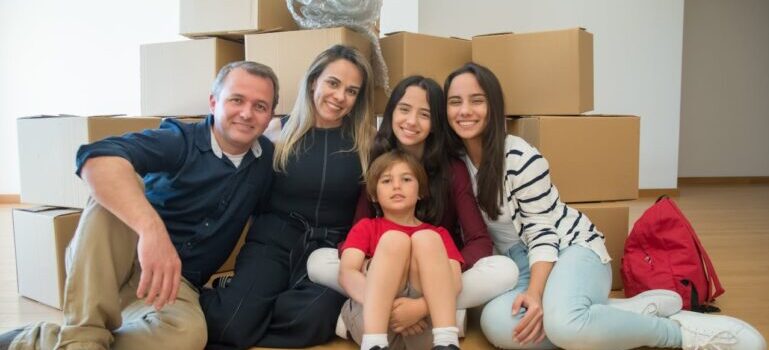 A family sitting near moving boxes and waiting for movers Monroe CT