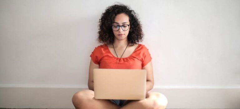 A woman sitting and chatting on her laptop