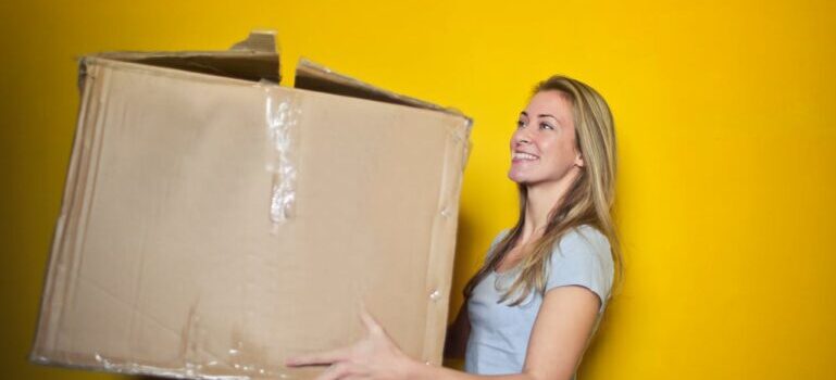 A woman holding big box and waiting for movers Brookfield CT locals love