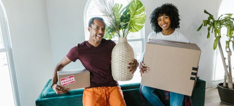 A man and woman holding stuff ready to call moving companies New Haven CT