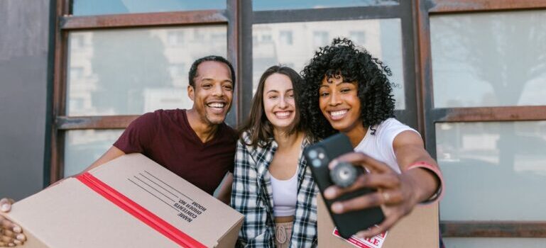 Three people taking selfie while waiting for movers Westport CT has to offer