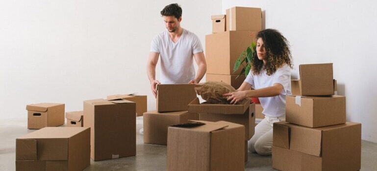 couple packing stuff into boxes