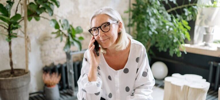 woman talking on her phone and sitting