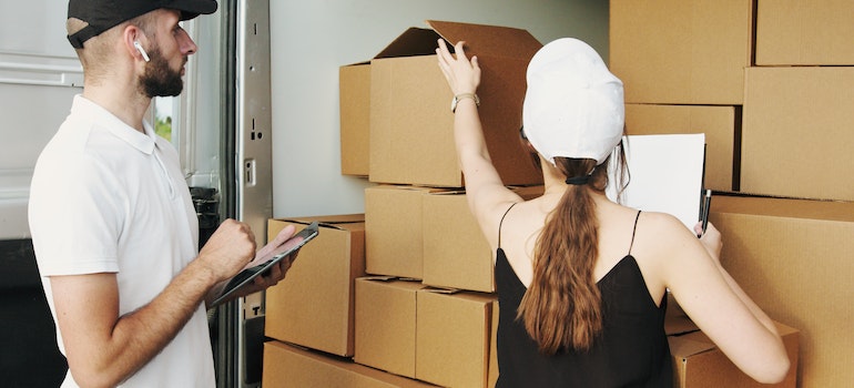 Packers putting moving boxes in a truck