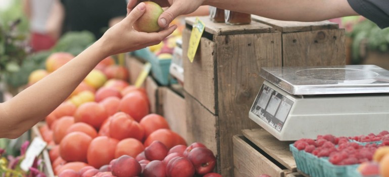 A woman buying at one of the local farmers' markets in Greenwich