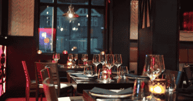 Restaurant set table with wine glasses and nice lighting.