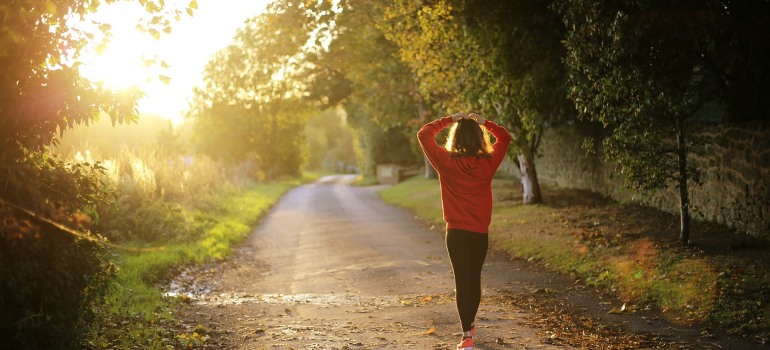 A fitness girl walking on a trail.