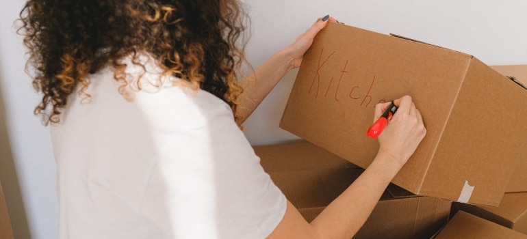 Person packing items for storage 