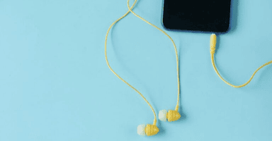 A cell phone with a pair of headphones