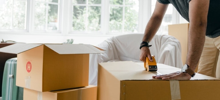 Person using packing supplies provided by the Cheshire movers