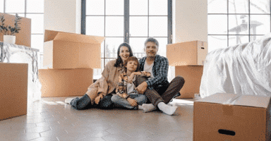 A Newly Moved Family Sitting on the Floor