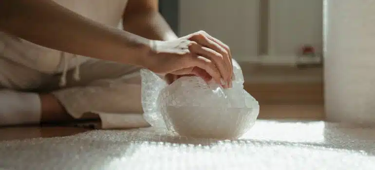 A person wrapping something before movers and packers CT come