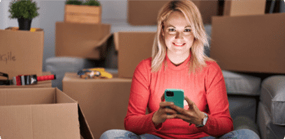 girl with moving boxes and a phone searching for movers located near me