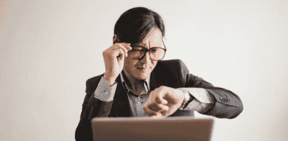 Man looking at his watch while waiting for his last minute movers to arrive