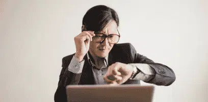 Man looking at his watch while waiting for his last minute movers to arrive