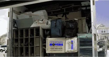 moving truck filled with packed boxes and household goods: utilizing packing services