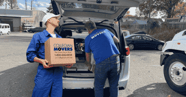 professional movers stratford helping load a clients car with moving boxes